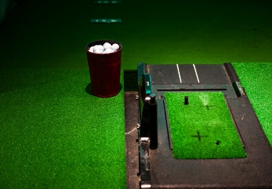 bunch of golf balls in a cup for Golf indoor simulator