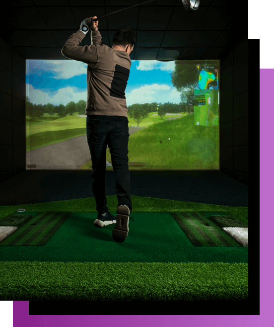 Man doing a perfect golf swing at Indoor golf simulator - The Manor