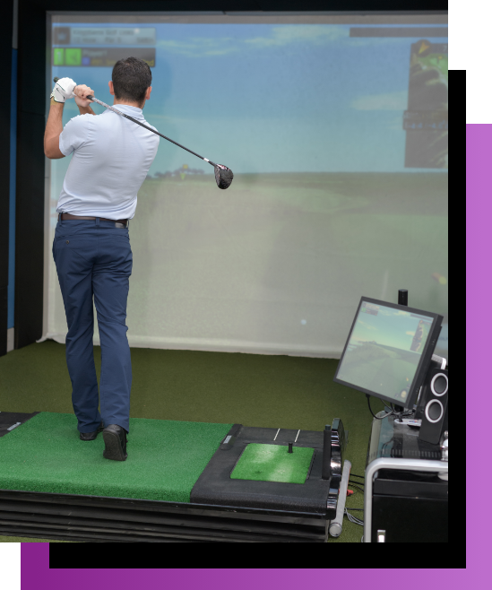 Man playing golf with The Manor's indoor golf simulator set up